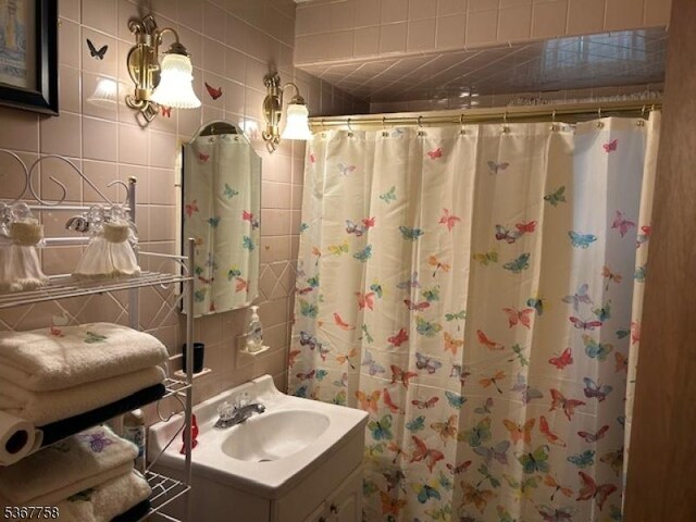 2081 Portland Ave, Scotch Plains Twp, NJ 07076 - bathroom with vanity, tile walls, and a shower with shower curtain