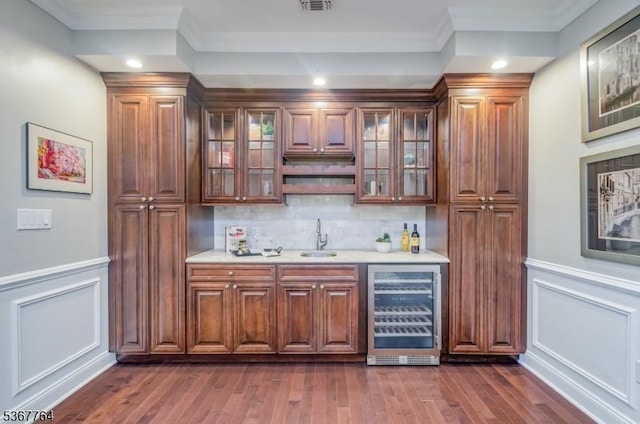 106 Woodbine Cir, New Providence Boro, NJ 07974 - indoor wet bar with a decorative wall, beverage cooler, ornamental molding, dark wood-style flooring, and a wainscoted wall