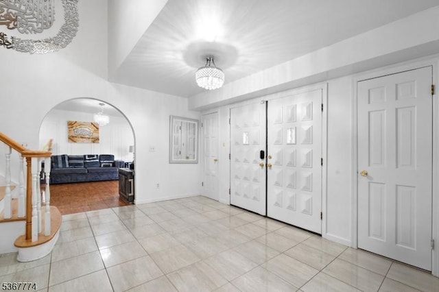 5 Peppermint Hill Rd, North Brunswick Twp, NJ 08902 - entrance foyer with a chandelier, light tile patterned floors, and arched walkways
