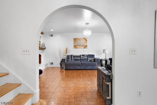 5 Peppermint Hill Rd, North Brunswick Twp, NJ 08902 - living room with arched walkways, stairs, and a chandelier