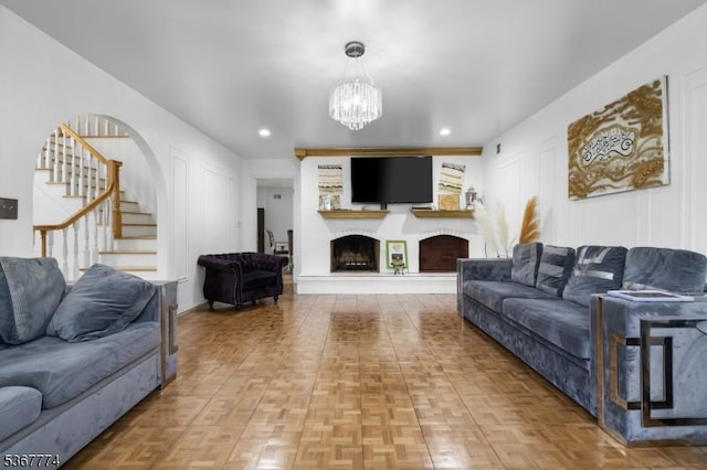 5 Peppermint Hill Rd, North Brunswick Twp, NJ 08902 - living area with stairs, a chandelier, a fireplace with raised hearth, recessed lighting, and a decorative wall