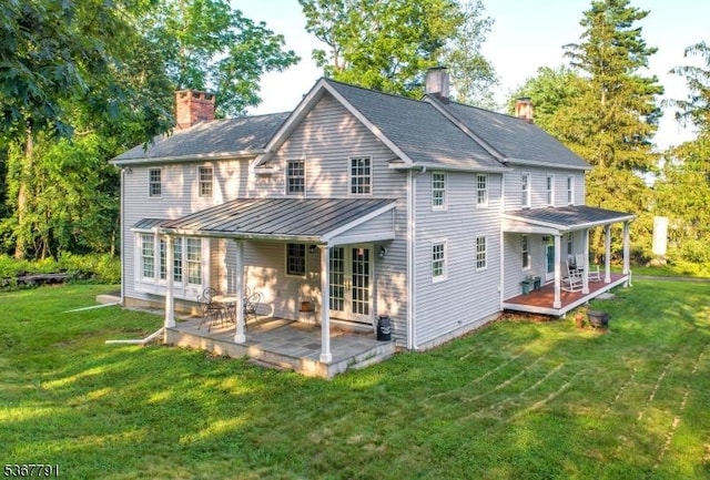 30 Bissell Rd, Tewksbury Twp, NJ 08833 - rear view of house with a chimney, a lawn, french doors, and a standing seam roof