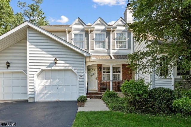 42 Carriage Ln, Sparta Twp, NJ 07871 - multi unit property featuring covered porch, asphalt driveway, a garage, and a chimney
