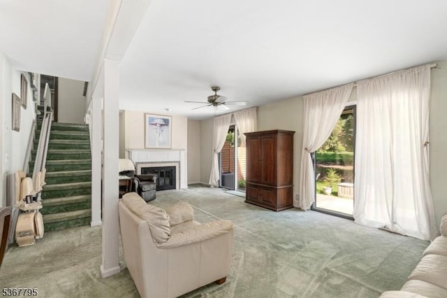 42 Carriage Ln, Sparta Twp, NJ 07871 - living area with light carpet, a ceiling fan, stairway, and a glass covered fireplace