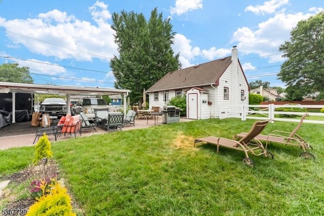 947 Boesel Ave, Manville Boro, NJ 08835 - rear view of house featuring a carport, a patio, and an outbuilding