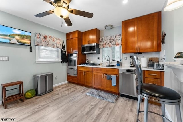 947 Boesel Ave, Manville Boro, NJ 08835 - kitchen featuring appliances with stainless steel finishes, light countertops, a warming drawer, and brown cabinets
