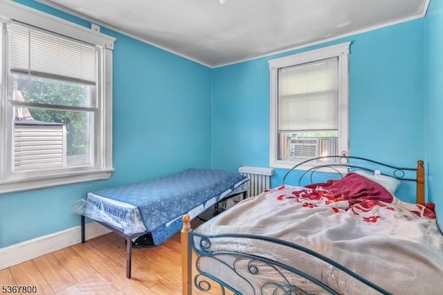 1705 Essex St, Rahway City, NJ 07065 - bedroom with wood finished floors, crown molding, cooling unit, and radiator