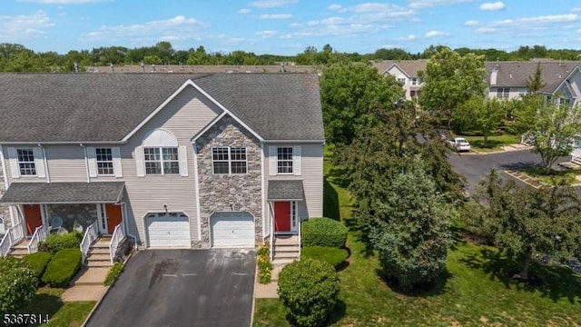 16 Edith Dr, Franklin Twp, NJ 08873 - view of front of house with stone siding, driveway, and an attached garage