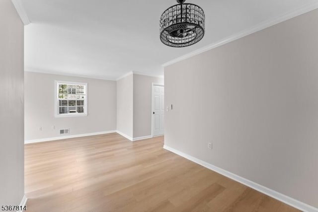 16 Edith Dr, Franklin Twp, NJ 08873 - unfurnished room with ornamental molding, light wood-style flooring, and a chandelier