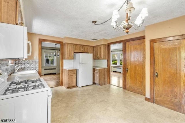 173 Raab Ave, Bloomfield Twp, NJ 07003 - kitchen featuring white appliances, a chandelier, radiator, tasteful backsplash, and brown cabinets