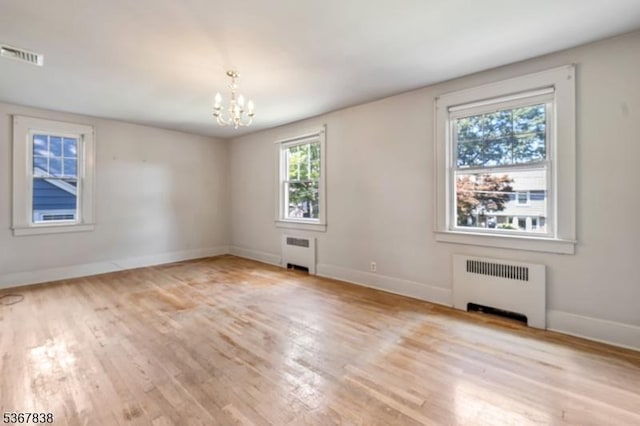 173 Raab Ave, Bloomfield Twp, NJ 07003 - empty room featuring radiator heating unit, a chandelier, and wood finished floors