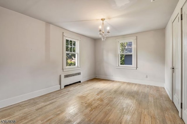 173 Raab Ave, Bloomfield Twp, NJ 07003 - spare room featuring radiator, a chandelier, healthy amount of natural light, and light wood finished floors