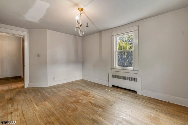 173 Raab Ave, Bloomfield Twp, NJ 07003 - unfurnished room with radiator heating unit, hardwood / wood-style flooring, and a chandelier