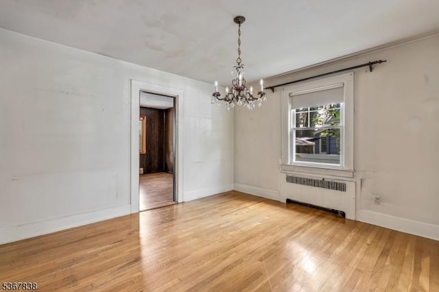 173 Raab Ave, Bloomfield Twp, NJ 07003 - spare room featuring radiator, a chandelier, and light wood-style flooring