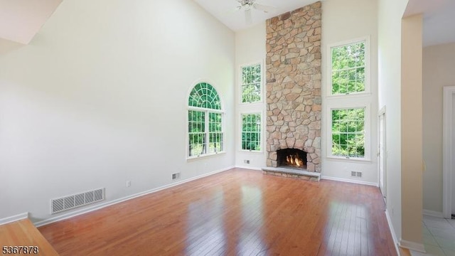 64 Sneider Rd, Warren Twp, NJ 07059 - unfurnished living room with high vaulted ceiling, hardwood / wood-style floors, a fireplace, and ceiling fan