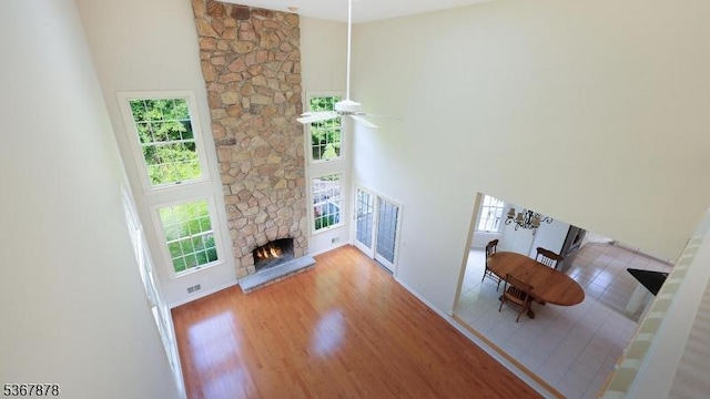 64 Sneider Rd, Warren Twp, NJ 07059 - living room with a towering ceiling, a fireplace, wood finished floors, and a ceiling fan