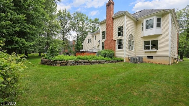 64 Sneider Rd, Warren Twp, NJ 07059 - rear view of house with a chimney and a lawn
