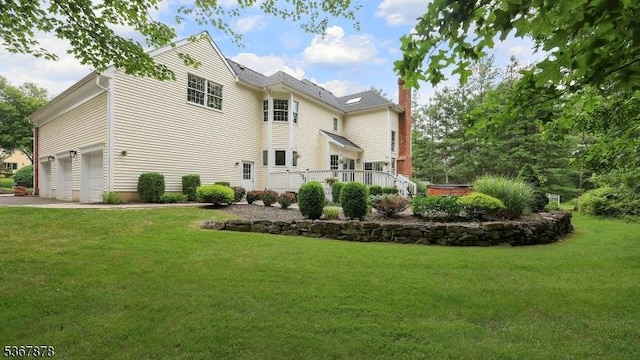64 Sneider Rd, Warren Twp, NJ 07059 - rear view of property featuring a yard, a garage, a chimney, and driveway