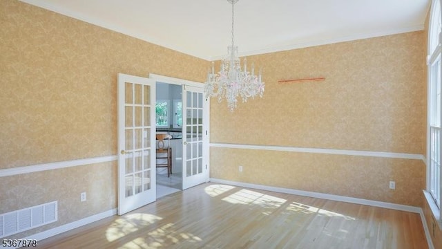 64 Sneider Rd, Warren Twp, NJ 07059 - unfurnished room featuring french doors, wood finished floors, wallpapered walls, a chandelier, and ornamental molding
