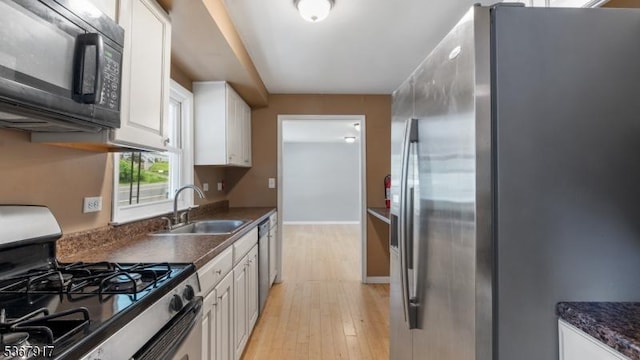 18 State Route 94, Blairstown Twp, NJ 07825 - kitchen with stainless steel appliances, light wood finished floors, white cabinetry, and dark countertops
