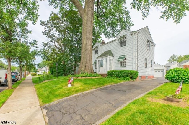 408 Sanford Ave, Hillside Twp, NJ 07205 - view of front facade with a front lawn, a detached garage, and a chimney