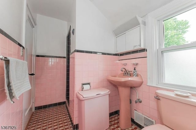 408 Sanford Ave, Hillside Twp, NJ 07205 - bathroom with tile walls, a wainscoted wall, and tile patterned floors