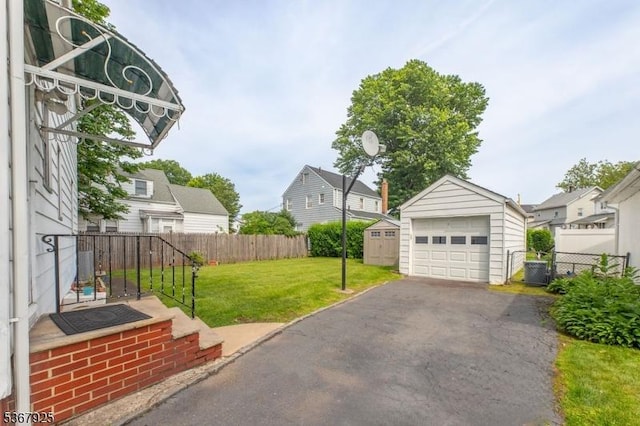 408 Sanford Ave, Hillside Twp, NJ 07205 - view of yard featuring a detached garage, a residential view, driveway, and a shed