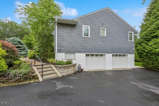 11 Old Farm Rd, North Caldwell Boro, NJ 07006 - view of property exterior featuring asphalt driveway and an attached garage