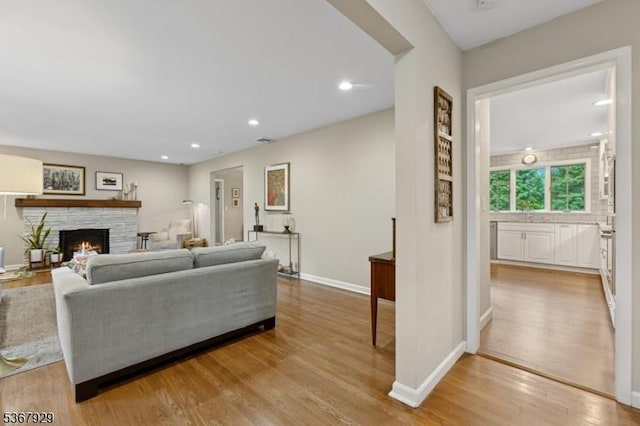 11 Old Farm Rd, North Caldwell Boro, NJ 07006 - living room featuring a stone fireplace, light wood-type flooring, and recessed lighting