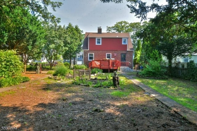 36 Grove St, Waldwick Boro, NJ 07463 - back of property featuring a wooden deck, brick siding, and a chimney