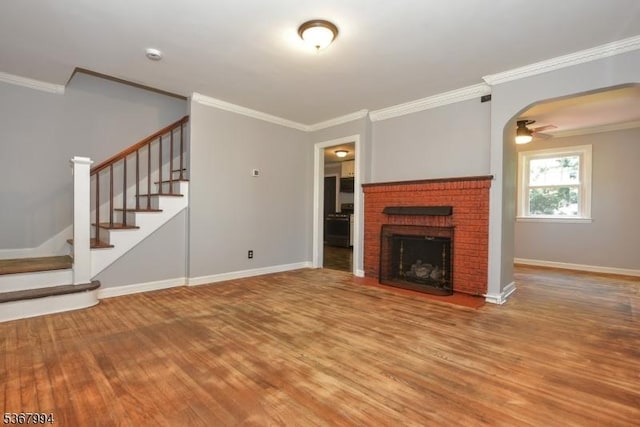 36 Grove St, Waldwick Boro, NJ 07463 - unfurnished living room featuring wood finished floors, stairway, ceiling fan, a brick fireplace, and crown molding