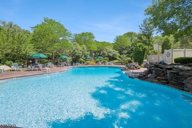 1407 Four Seasons Dr Unit 1407, Wayne Twp, NJ 07470 - community pool with a patio and view of scattered trees