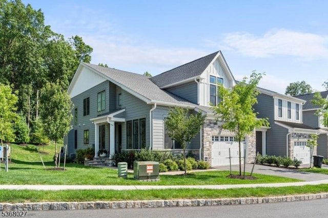28 Peacock Ln Unit 28, Berkeley Heights Twp, NJ 07922 - view of front facade with an attached garage, driveway, a front lawn, stone siding, and board and batten siding
