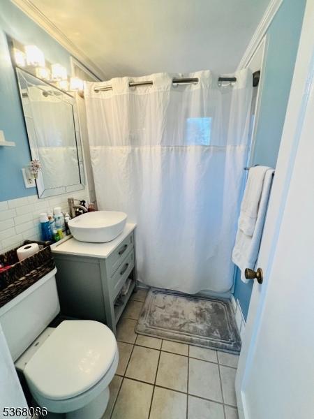185 High St, Metuchen Boro, NJ 08840 - full bathroom with vanity, curtained shower, and tile patterned flooring
