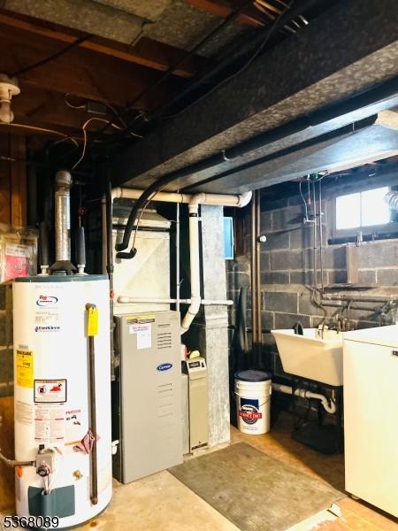 3 Gregory Ter, Belleville Twp, NJ 07109 - below grade area with gas water heater, washer / dryer, and refrigerator