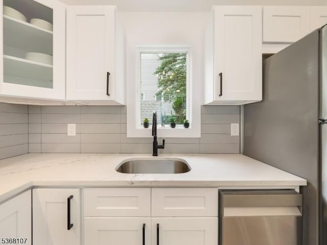 8 Blanche Dr, Jefferson Twp, NJ 07849 - kitchen featuring white cabinetry, tasteful backsplash, dishwasher, freestanding refrigerator, and glass insert cabinets