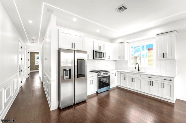 109 Fulton St, Elizabeth City, NJ 07206 - kitchen with appliances with stainless steel finishes, light countertops, healthy amount of natural light, white cabinets, and recessed lighting