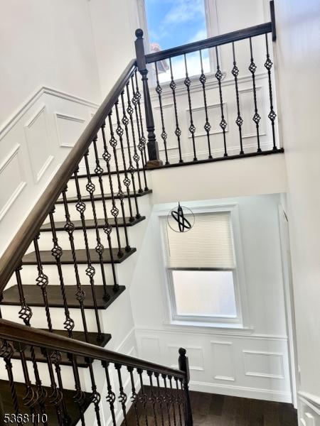 109 Fulton St, Elizabeth City, NJ 07206 - stairway featuring a decorative wall, healthy amount of natural light, wood finished floors, and wainscoting