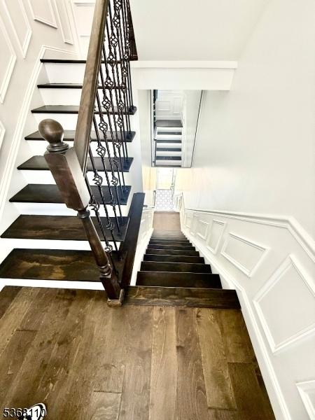 109 Fulton St, Elizabeth City, NJ 07206 - stairway featuring wood finished floors, a decorative wall, wainscoting, and built in features