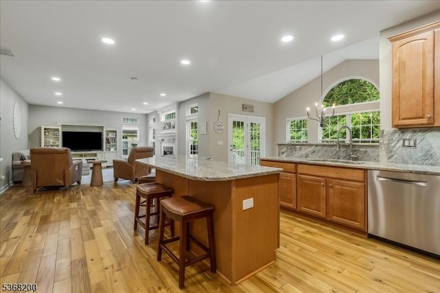 40 Primrose Ln, Sparta Twp, NJ 07871 - kitchen featuring stainless steel dishwasher, light wood-style floors, a kitchen breakfast bar, light stone countertops, and recessed lighting