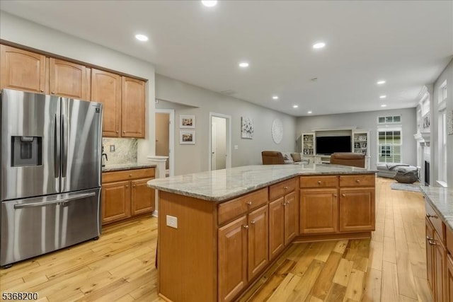 40 Primrose Ln, Sparta Twp, NJ 07871 - kitchen featuring stainless steel fridge, open floor plan, light wood-style floors, light stone counters, and recessed lighting