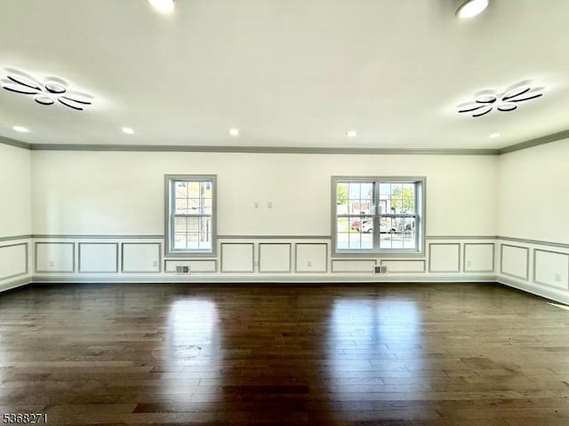 47 Bird Ave, Woodbridge Twp, NJ 08830 - unfurnished room with healthy amount of natural light, crown molding, dark wood-type flooring, a decorative wall, and wainscoting