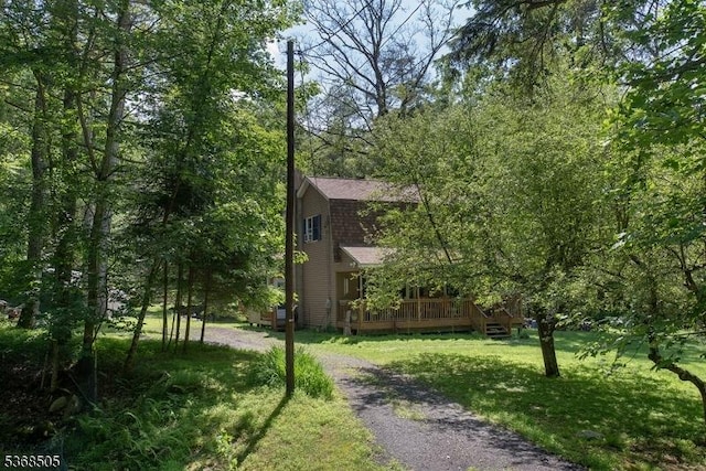 115 Bierskill Rd, Montague Twp, NJ 07827 - view of green lawn featuring a deck and dirt driveway