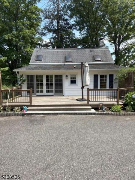 196 Littleton Rd, Morris Plains Boro, NJ 07950 - view of front of property with a wooden deck, french doors, and a chimney