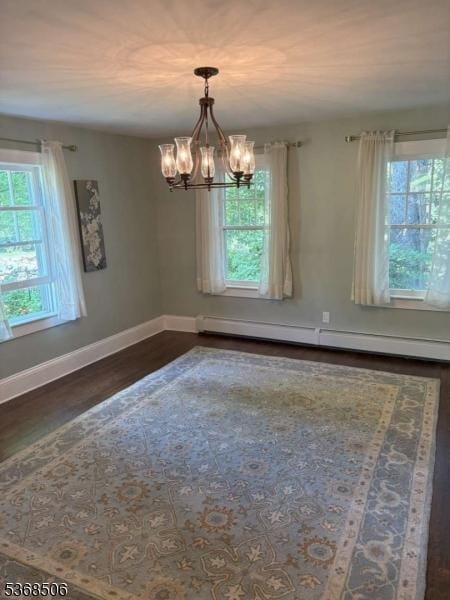 196 Littleton Rd, Morris Plains Boro, NJ 07950 - unfurnished room with a baseboard radiator, a chandelier, and dark wood-type flooring