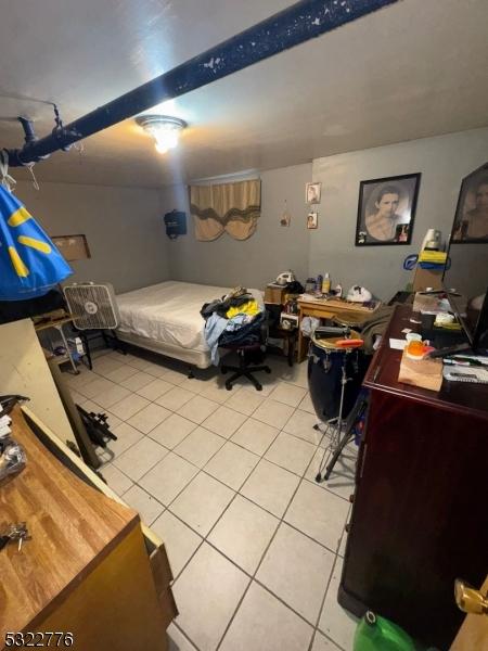 393 E 38th St, Paterson City, NJ 07504 - bedroom with light tile patterned floors