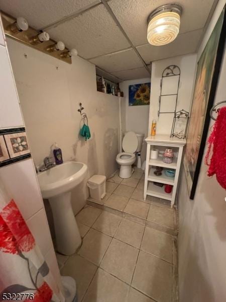 393 E 38th St, Paterson City, NJ 07504 - full bathroom with tile patterned floors, a drop ceiling, and a shower with shower curtain