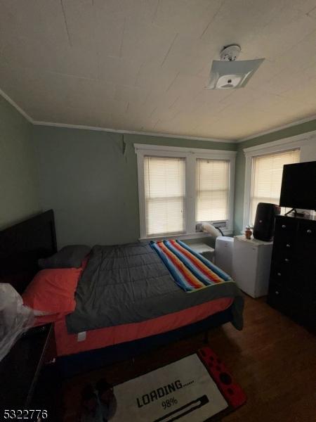 393 E 38th St, Paterson City, NJ 07504 - bedroom with crown molding and wood finished floors