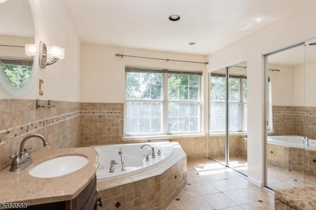76 Avebury Pl, Franklin Twp, NJ 08873 - bathroom with a bath, tile patterned flooring, vanity, and tile walls