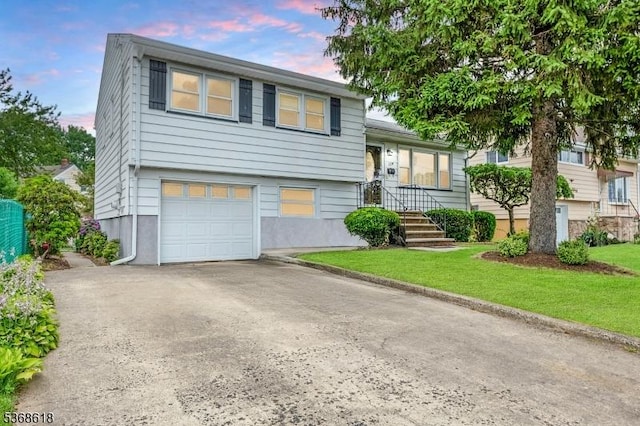 724 Bloomfield Ave, Clifton City, NJ 07012 - tri-level home featuring a garage, driveway, and a yard